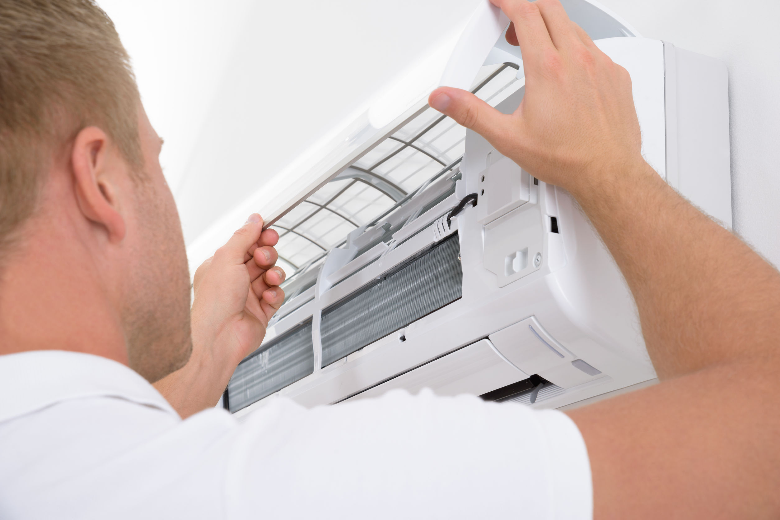 Man Adjusting Air Conditioning System